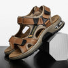 A pair of brown men's genuine leather air cushion sandals resting on a dark surface.