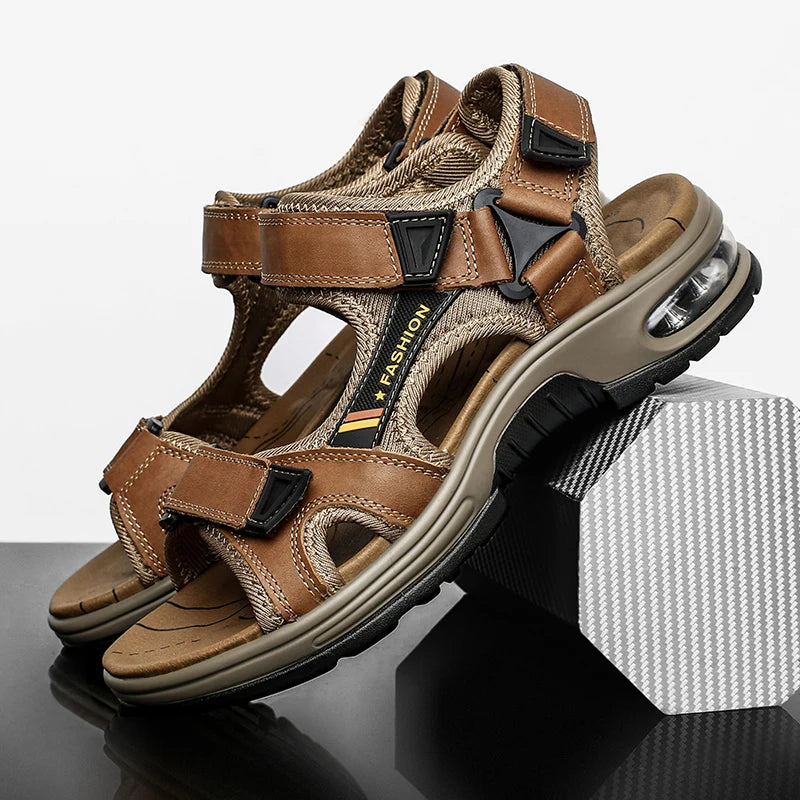 A pair of brown men's genuine leather air cushion sandals resting on a dark surface.