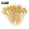 A pile of gold pearl bamboo skewers used for party appetizers and desserts.