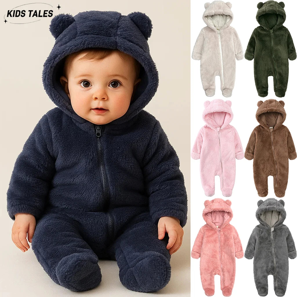A baby wearing a dark blue fleece hooded romper with a zipper, shown in a studio setting.