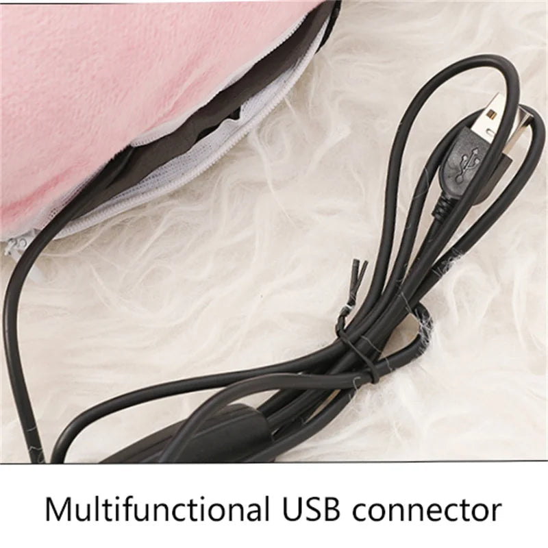 A black multifunctional USB connector cable lying on a white, fluffy surface next to a pink fleece cover.
