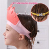 A pink and white silicone baby shampoo crown is shown being used on a child's hair while bathing.