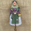 Handcrafted kitchen witch doll with antique charm featuring a woman in green and purple attire
