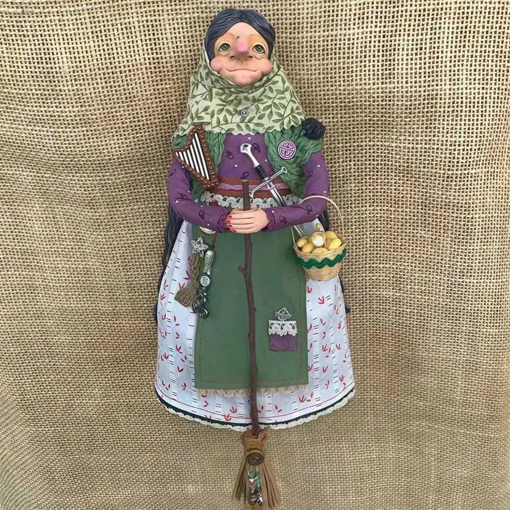 Handcrafted kitchen witch doll with antique charm featuring a woman in green and purple attire