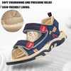 A close-up view of a navy blue and tan children's sport sandal with breathable lining and adjustable straps.