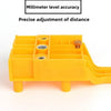 Yellow adjustable woodworking dowel drilling guide with millimeter level accuracy for precise distance adjustment