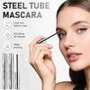 A woman applies steel tube mascara to her eyelashes, highlighting clear and distinct roots.