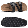 Black slide sandals with cork footbeds and braided straps shown from the side and bottom.