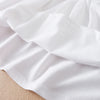 White kids summer cotton dress showing the fabric and turn-down collar detail.
