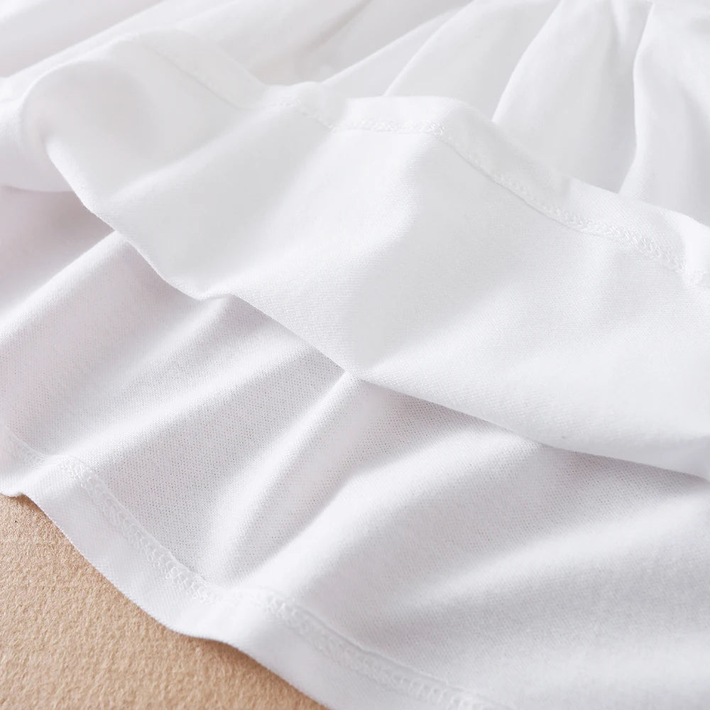 White kids summer cotton dress showing the fabric and turn-down collar detail.