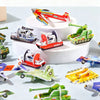 A collection of colorful foam animal puzzle pieces, including airplanes and tanks, arranged on a white surface.