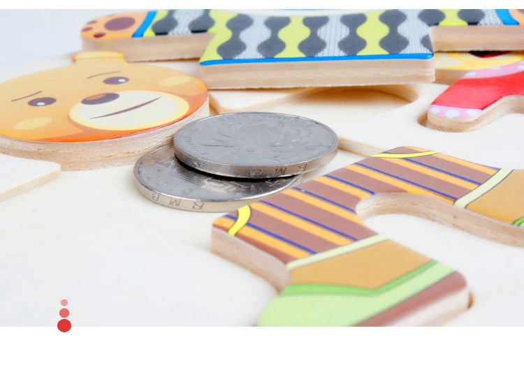 Wooden puzzle pieces shaped like a bear and other animals for Montessori dress-up play