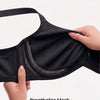 A hand is holding a black breathable mesh under-cup bra, showing its stretchy texture and design.