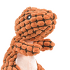 Jouet pour chien en forme de dinosaure en peluche à la peau texturée brune et noire avec un grand œil.