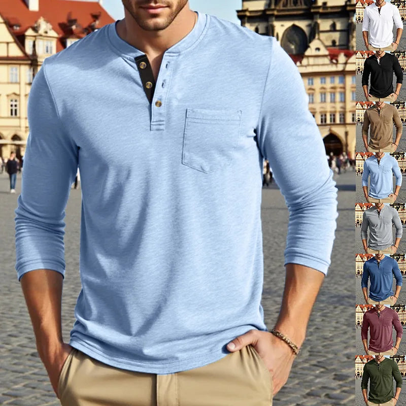 A man wearing a light blue long-sleeve casual shirt with a chest pocket, standing outdoors.
