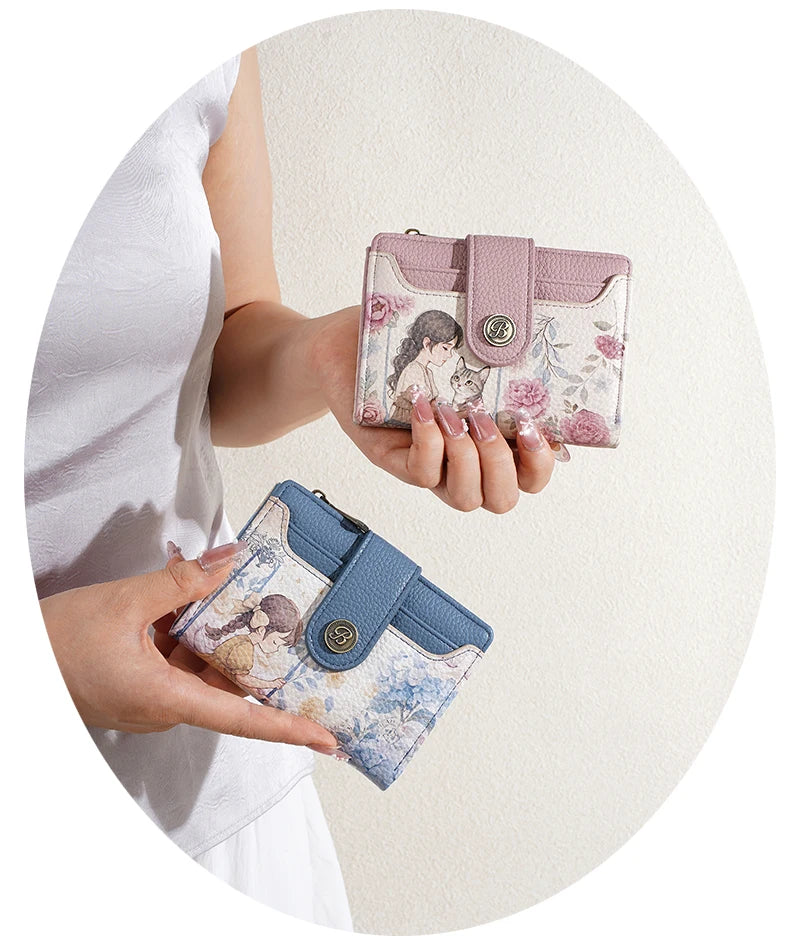 A hand holds a pink floral print women's wallet with a zipper and card slots against a light background.