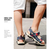 A close-up of a pair of navy blue and white boys' breathable summer sport sandals worn on a person's foot.