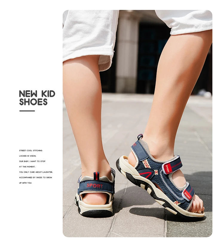 A close-up of a pair of navy blue and white boys' breathable summer sport sandals worn on a person's foot.