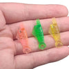 A hand holds a pack of five colored auto needle threaders for sewing machines, including orange, green, and yellow.