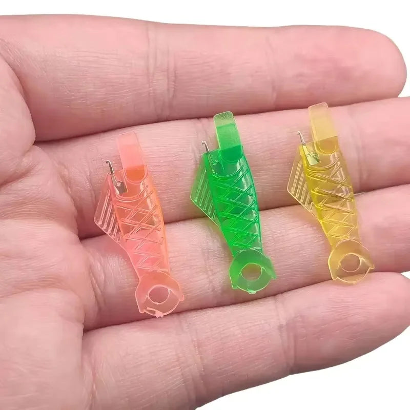 A hand holds a pack of five colored auto needle threaders for sewing machines, including orange, green, and yellow.