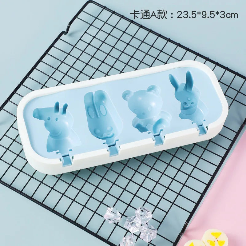 A white silicone mold tray containing several blue animal-shaped popsicle molds for kids
