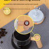 A close-up of a black mug with a wooden stirring stick, demonstrating the self-stirring function.