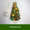 A festive Christmas tree decoration made of green lights and ribbon, suspended by a thin wire.