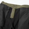 Black waterproof insulated fleece pants with olive green trim and zipper detail.
