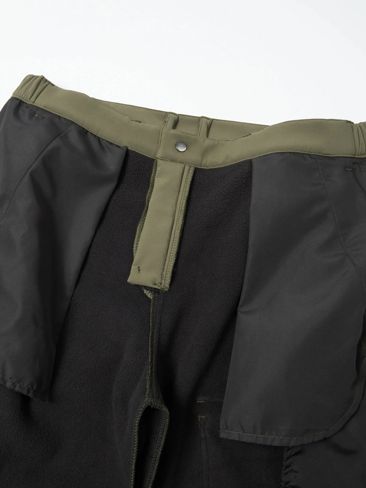 Black waterproof insulated fleece pants with olive green trim and zipper detail.