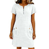 A woman wearing a white lightweight cotton-linen short sleeve dress with a collar and side pockets.