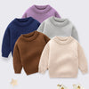 A collection of four soft knitted long-sleeve pullover sweaters in shades of purple, blue, gray, and brown.