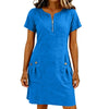 A woman wearing a bright blue lightweight cotton-linen short sleeve dress with a collar and front zipper and side pockets.