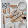 A wooden pretend play food cutting set for kids showing various wooden utensils and circular molds.
