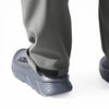 Close-up of a person wearing gray waterproof insulated fleece pants and boots.