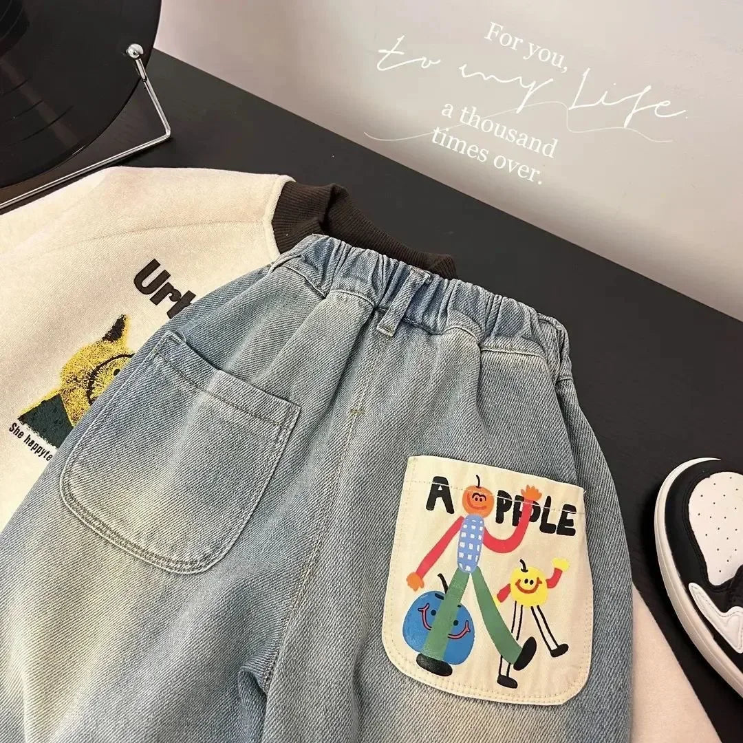 Close-up of light blue denim jeans with an elastic waist and a patch featuring an apple.