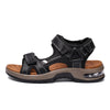 A pair of black men's genuine leather air cushion sandals with a tan sole and strap details.
