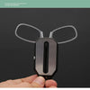 A close-up display of a pair of clear clip-on reading glasses with a black keychain case being held in a hand.