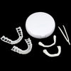 A white cosmetic denture teeth kit with a removable cover and several individual teeth molds.