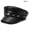 Black PU leather beret hat with a gold heart logo and decorative brass accents.