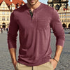 A man wearing a maroon long-sleeve casual shirt with a chest pocket, standing outdoors.