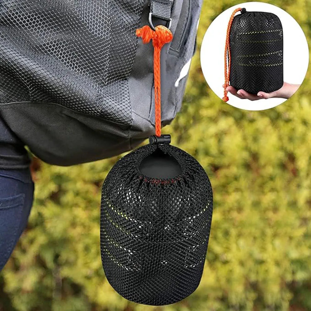 A black mesh cooking kit hangs from a gray backpack strap, shown next to a hand holding the same item.