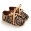 Pair of leopard print baby first walkers with soft rubber soles