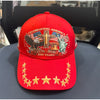 Red baseball cap featuring a patriotic graphic design with an eagle and a statue of liberty.