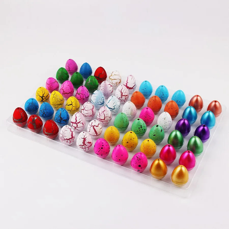 A collection of colorful dinosaur hatching eggs in various shades of green, pink, red, and blue arranged in a plastic tray.