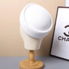 A white straw pillbox sun hat displayed on a mannequin against a light background.
