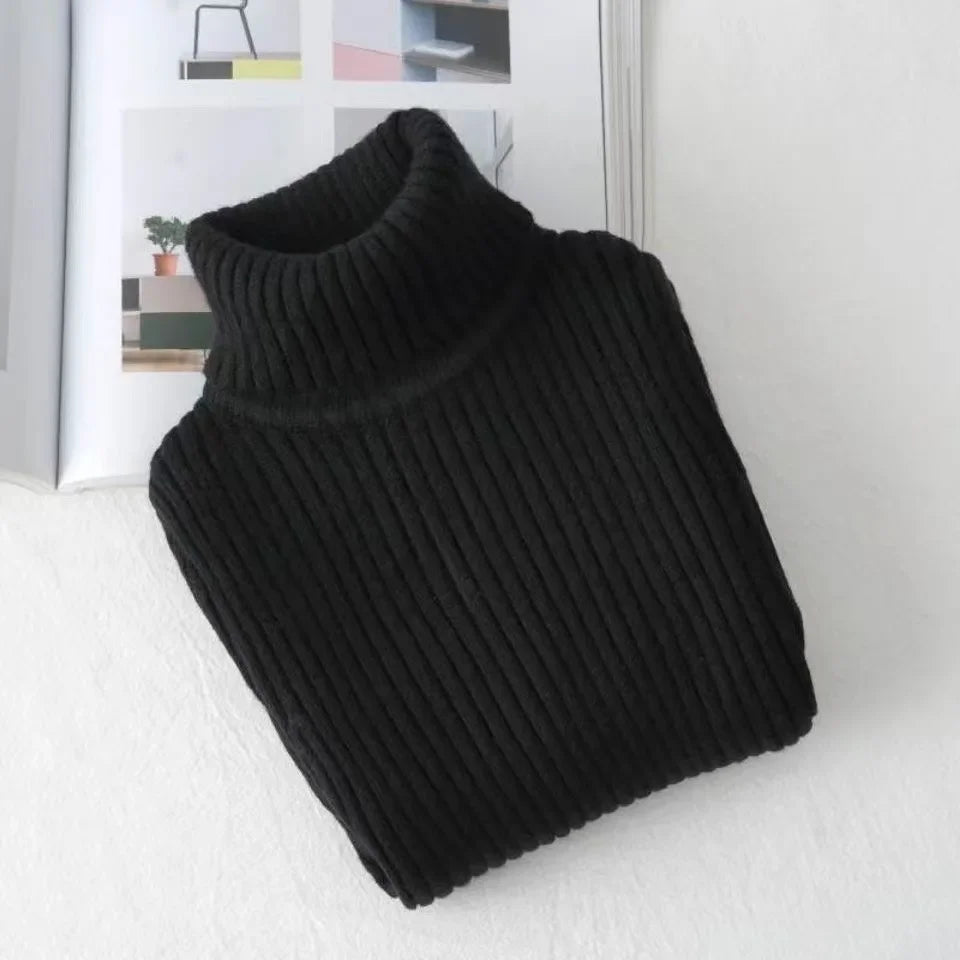 A black knit turtleneck sweater for kids displayed on a white surface.