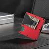 A red slim RFID-blocking wallet with a black removable money clip and a stack of US dollar bills resting on a dark surface.