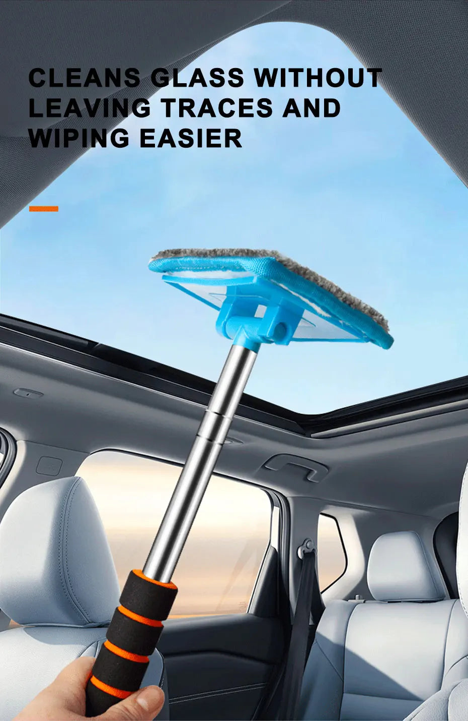 A hand holds a telescopic windshield cleaning brush with a blue head, positioned inside a car cabin.