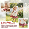 A girl wearing a white summer pinafore dress with strawberry and bunny print playing outdoors.
