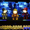 Three cartoon hero police night lights in white, yellow, and red are displayed on a dark surface.